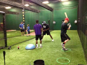 Darrian Graves (Duluth High School) works out with CJ Stewart in the Hitting Lab to prepare for a showcase, while Jason Shirley (Youngstown State University) gets ready for college summer league play. 